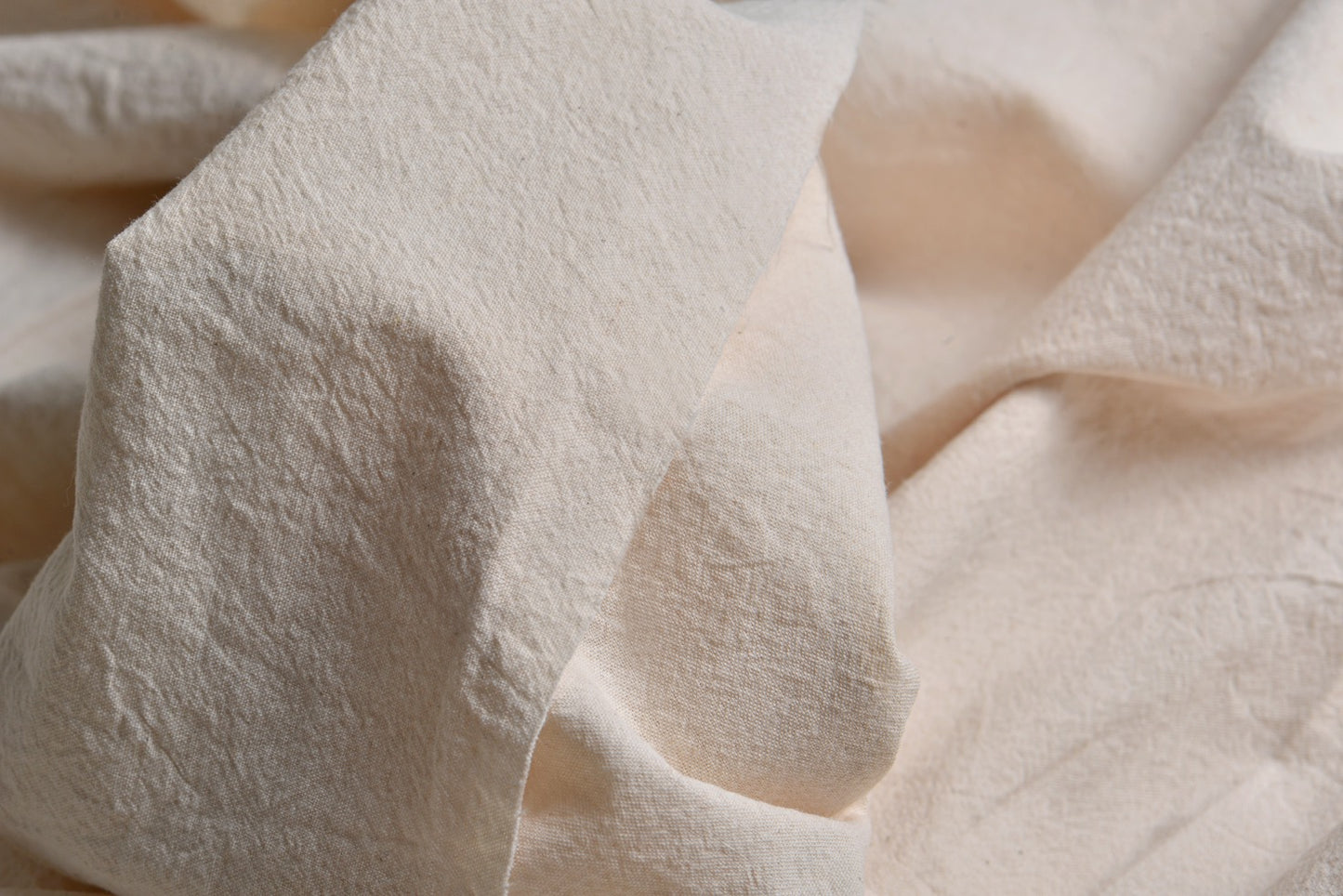 Close-up texture of undyed plain woven cotton fabric for natural dye projects
