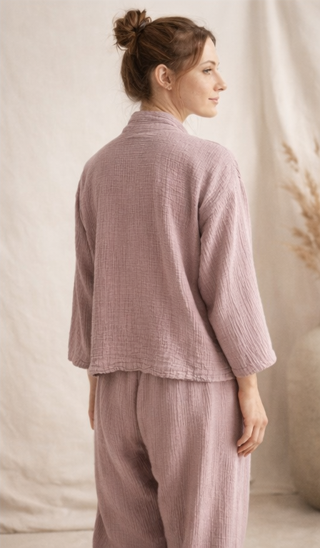 Back view of the naturally dyed muslin lounge set in powder lilac, relaxed fit 100% cotton top and pants.

