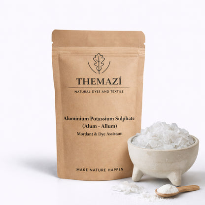 THEMAZÍ Alum (Potassium Aluminium Sulphate) pouch with alum crystals in a bowl and a small spoon of powder on a clean white background.