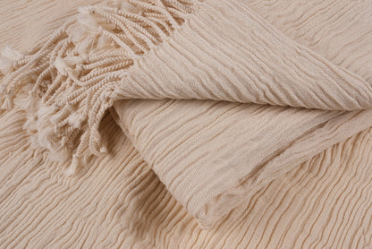 Close-up view of folded undyed cotton linen peshtemal showing natural fabric texture
