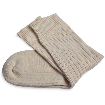 Folded undyed cotton socks prepared for natural dye application